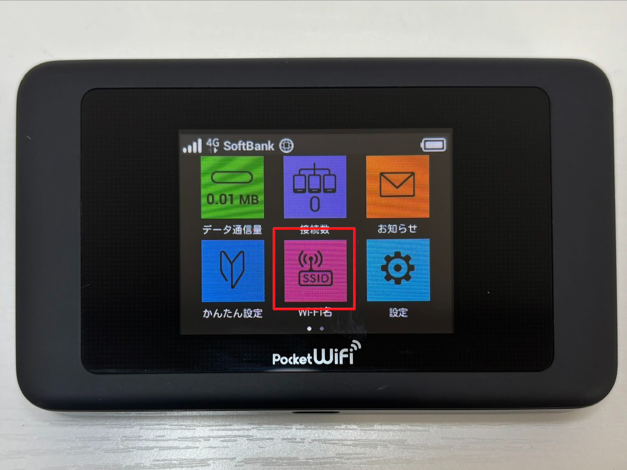 Pocket WiFi menu screen with six colored tiles, showing the pink SSID tile in the bottom row
